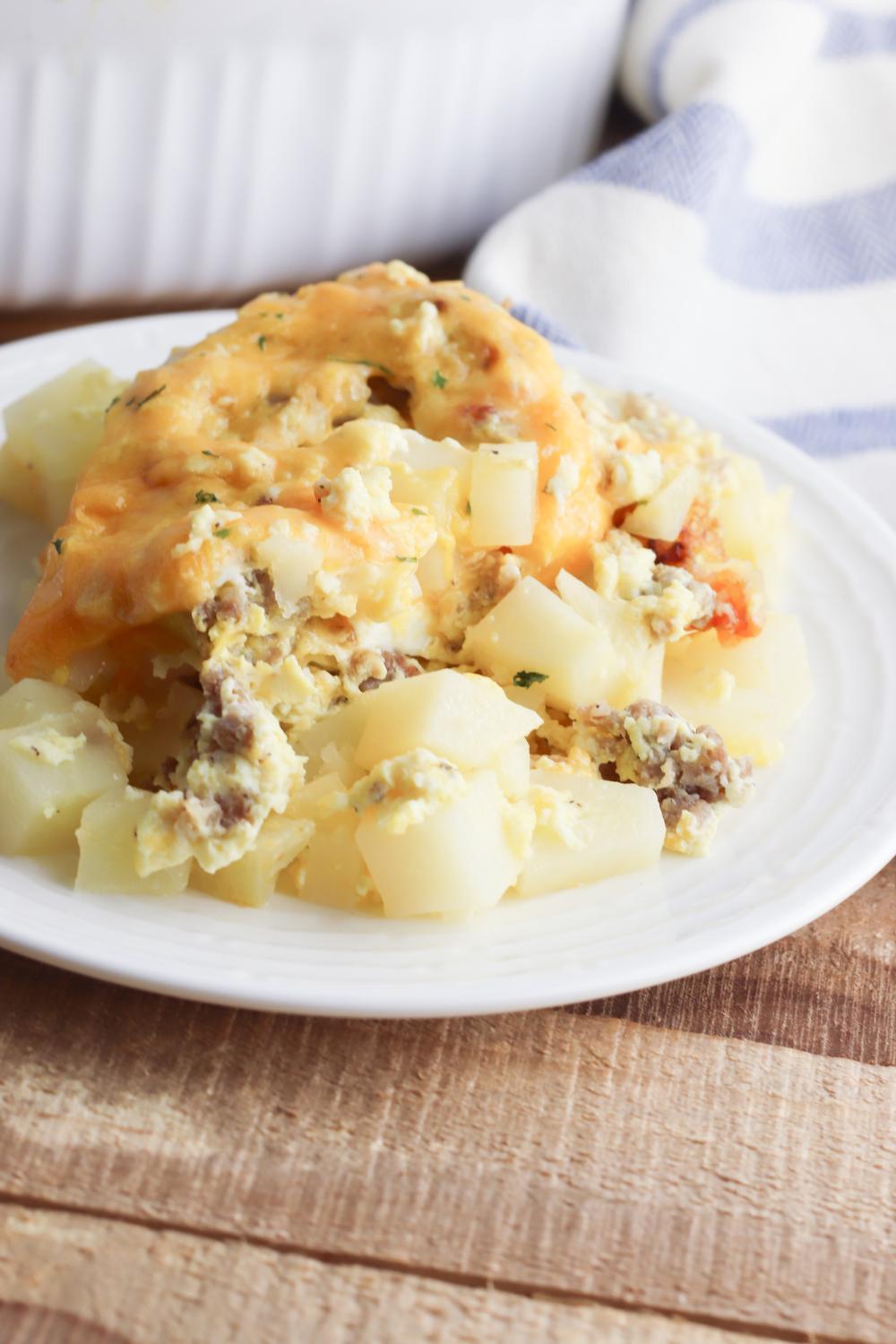 A plate with delicious sausage, potato, egg and cheese casserole ideal for breakfast or breakfast for dinner.