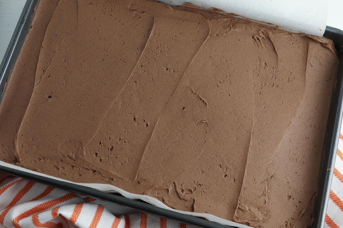 spread the frosting over the blondies in the pan ready to decorate for Halloween.