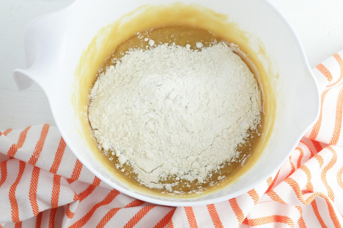 wet and dry ingredients for blondies ready to mix together in a bowl.