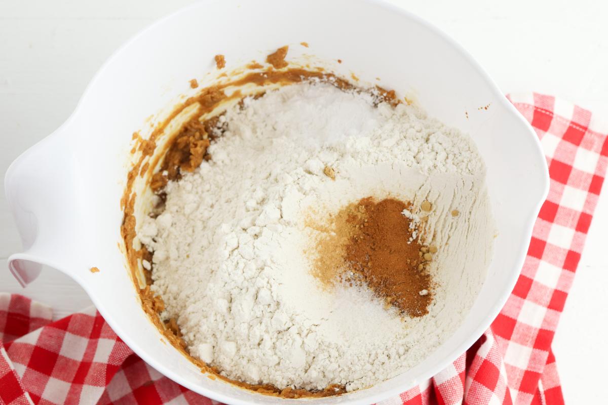 dry ingredients added to the bowl to mix including the spices for gingerbread men cookies.