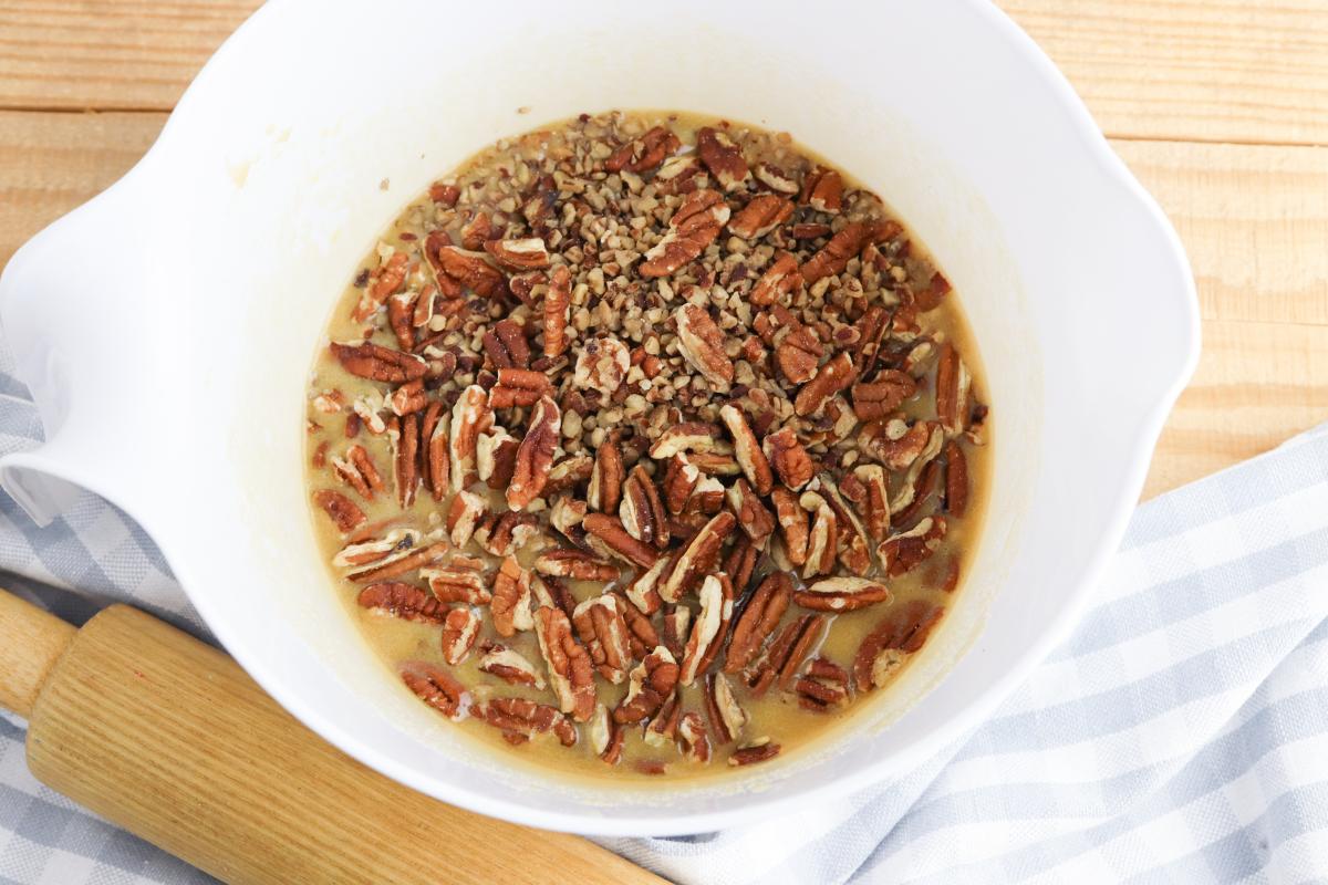 Pecan pieces and halves added to the pie filling mixture.