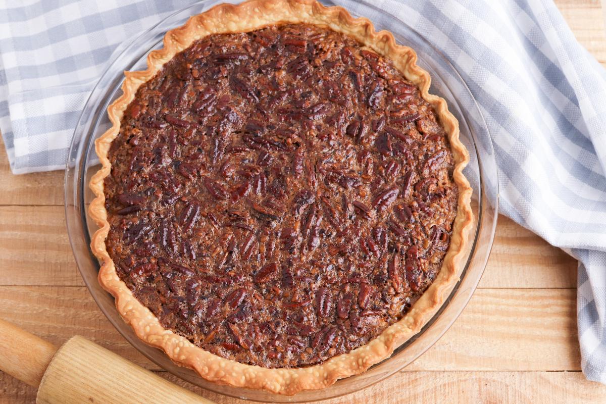 Baked homemade pecan pie out of the oven and cooling ready to be served to your holiday guests.